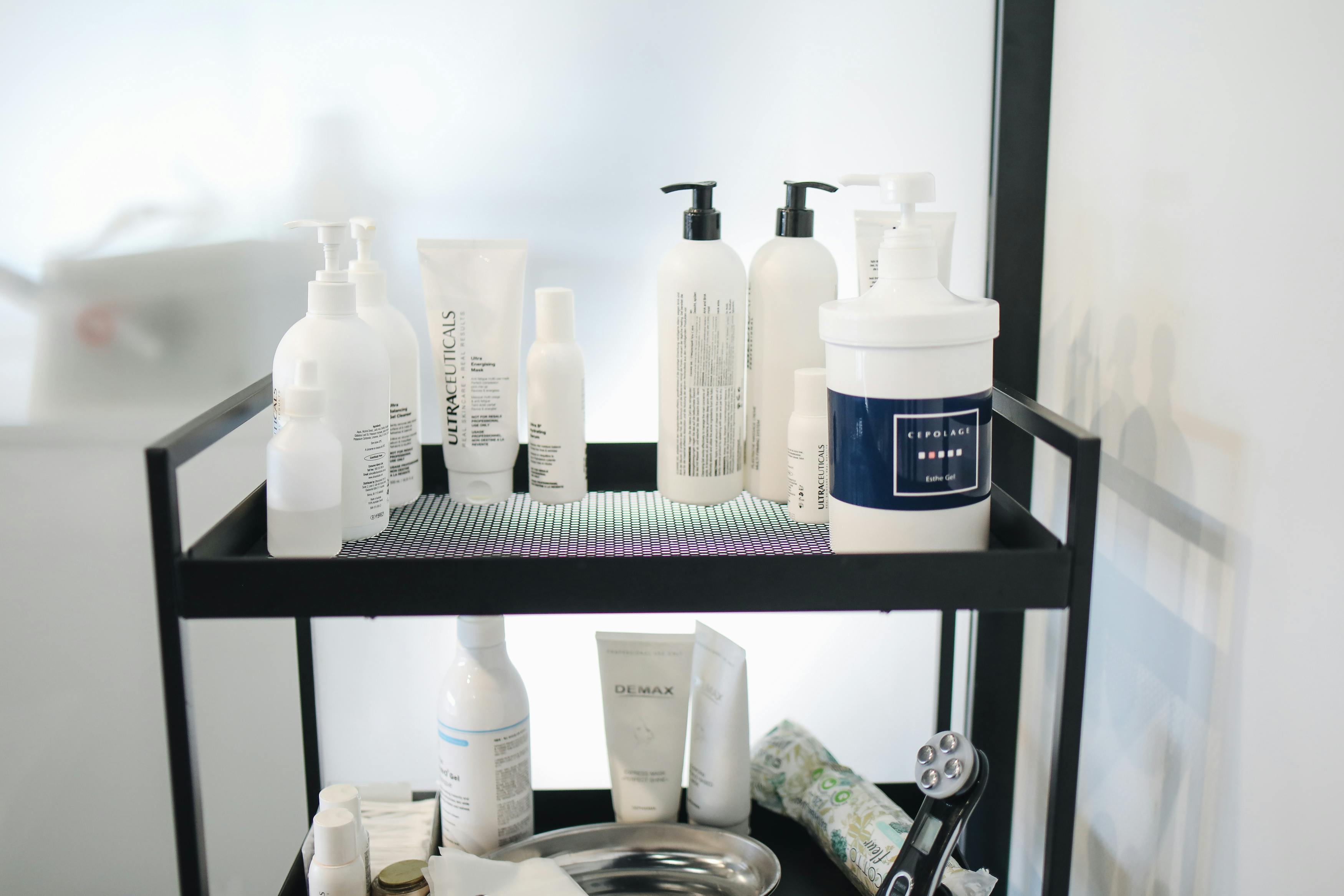 Slim rolling cart placed beside a bathroom sink holding towels and toiletries